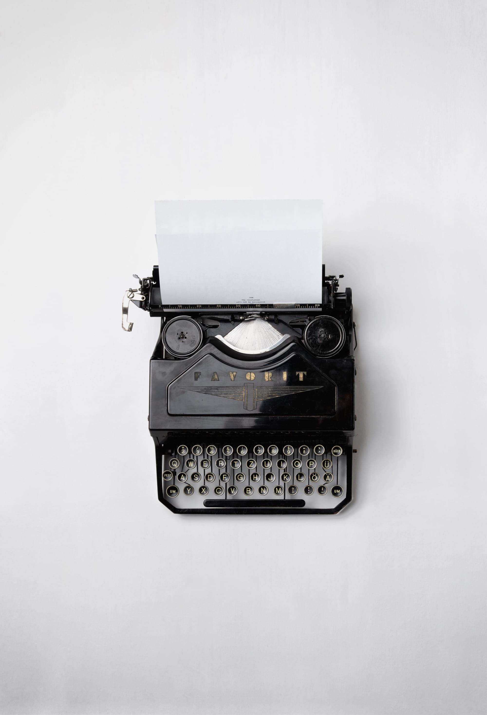 A black typerwriter against a white background