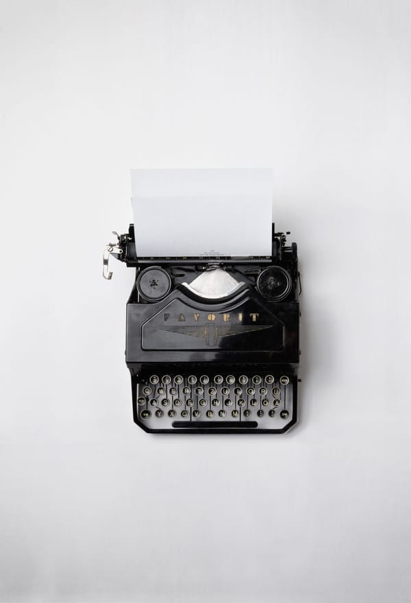 A black typerwriter against a white background